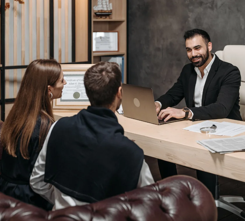 Financial advisor explaining credit card debt resolution plan to client using reports and calculator